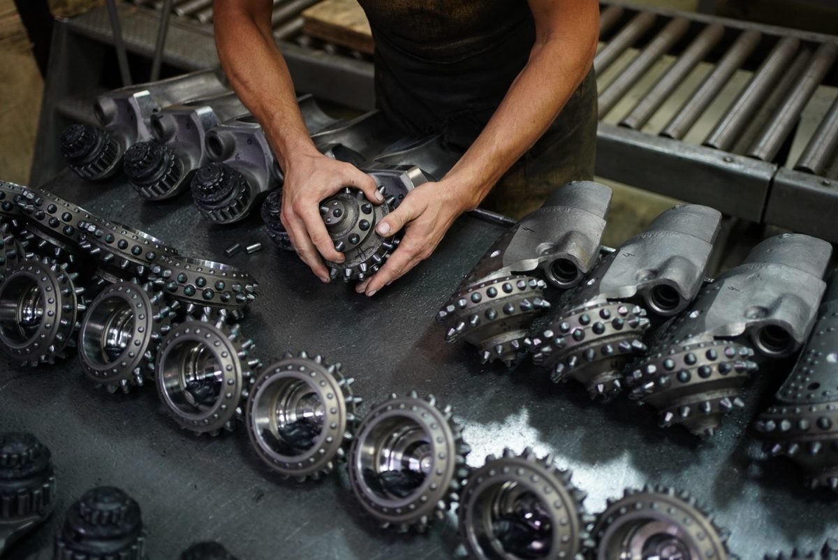 Roller cones fitted with tungsten carbide inserts during tricone bit assembly